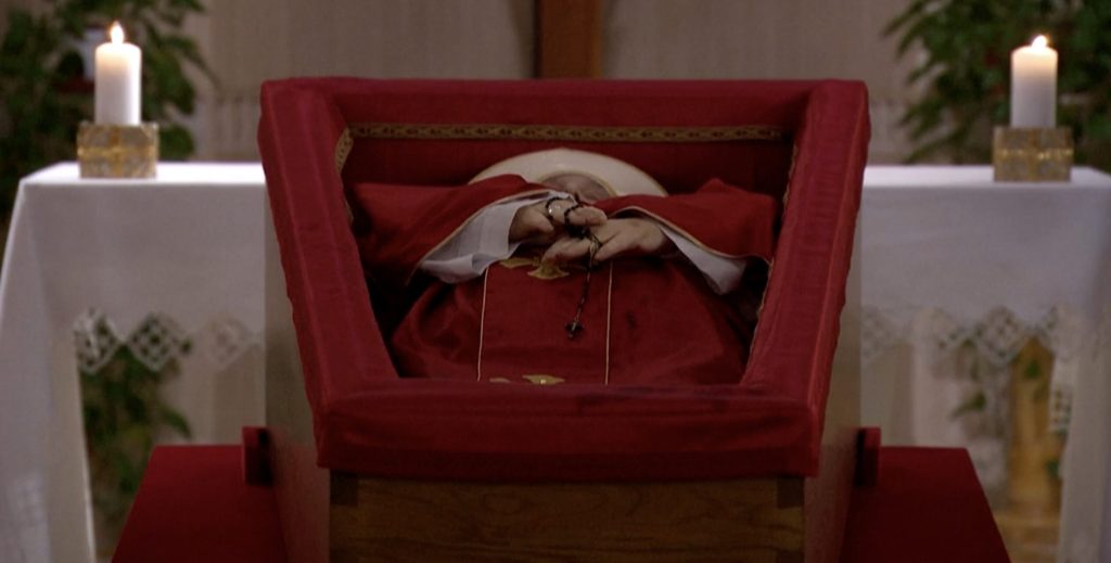 Red Casula and Rosario in his hands in the chapel of Santa Marta