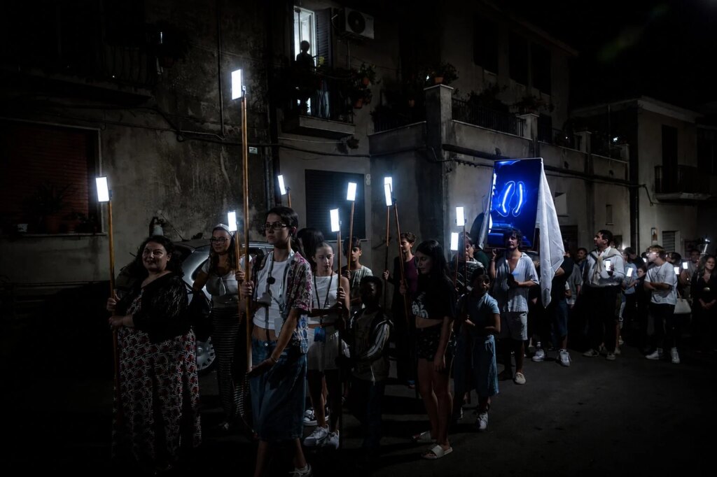 Il santo è uno schermo e i fedeli seguono l’IA: la processione digitale che divide il futuro della fede